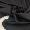 Stretch jersey piquet in polyester and elastane, black color reference Tap Shoe. Very soft, flowy, medium weight and not transparent. Ideal for trousers, dresses, skirts, and jackets. High-quality deadstock collected in Stock from a Maison de Couture in Italy.