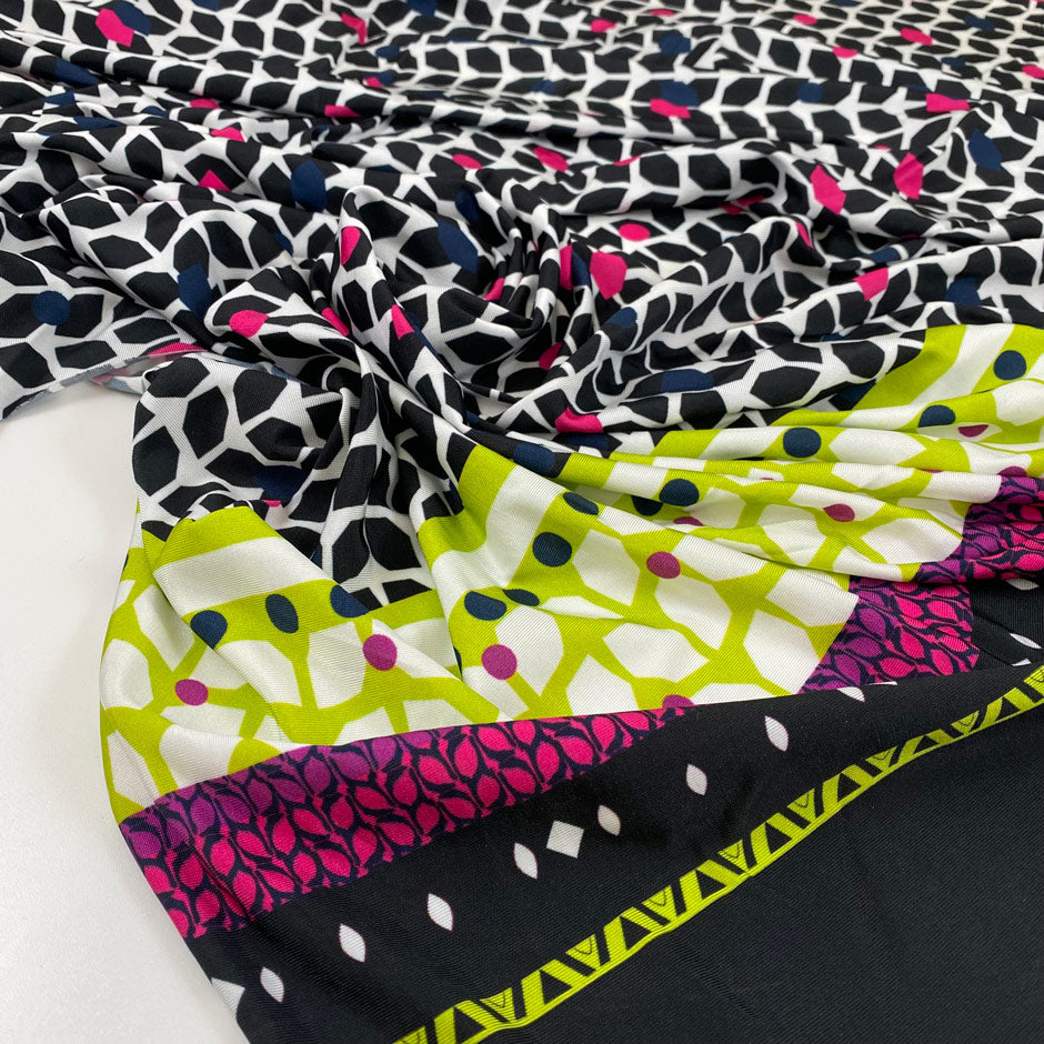 Pure viscose jersey with geometrical design in white, black, fuchsia, and green shades. Very soft, light, and stretchy. High-quality deadstock fabric collected in Stock from a Maison de Couture in Italy.