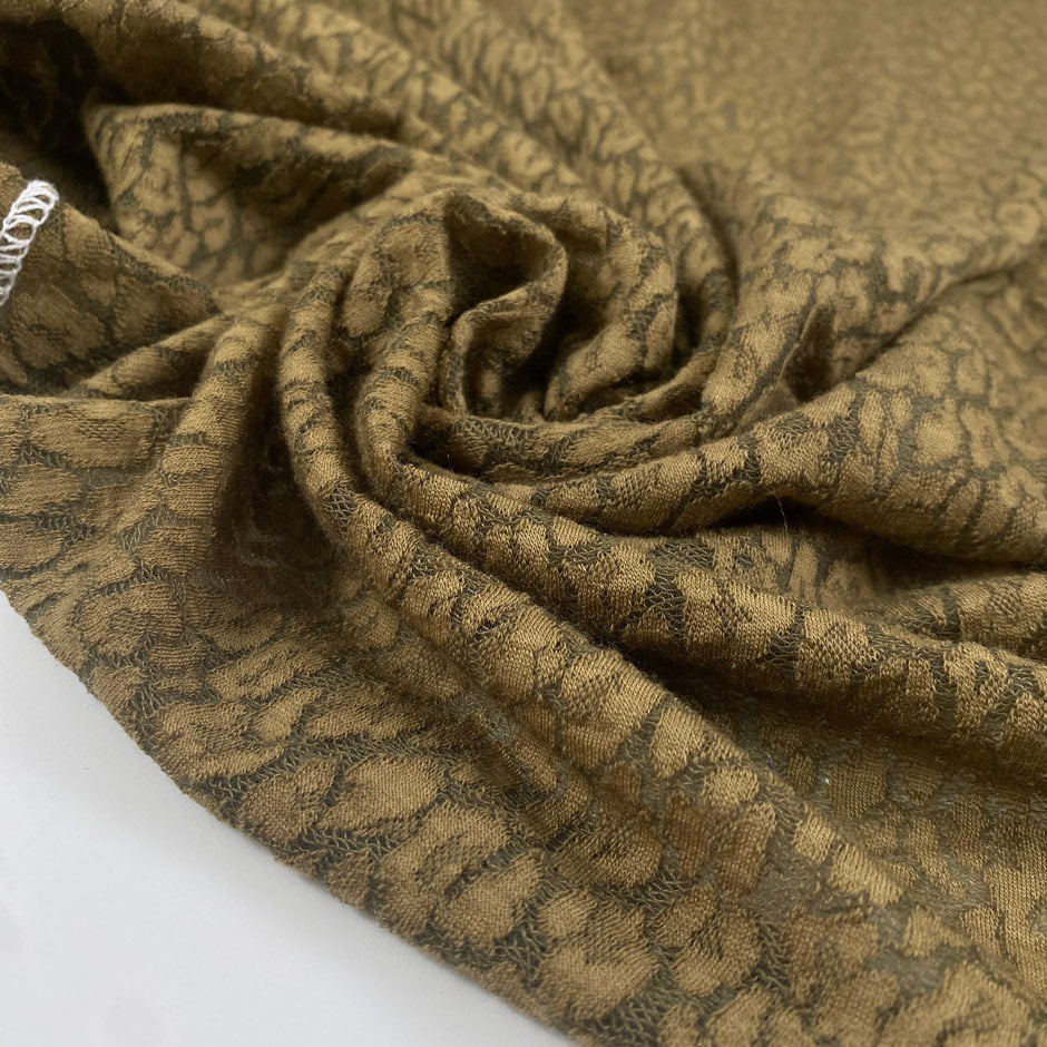 Green spotted wool jersey warm soft and slightly stretchy ideal for cozy tops dresses and light outerwear. High-quality deadstock collected in Stock from a Maison de Couture in Italy.