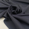 Soft knit polyester jersey piquet in anthracite piquet texture ideal for sporty garments and modern basics. High-quality deadstock collected in Stock from a Maison de Couture in Italy.