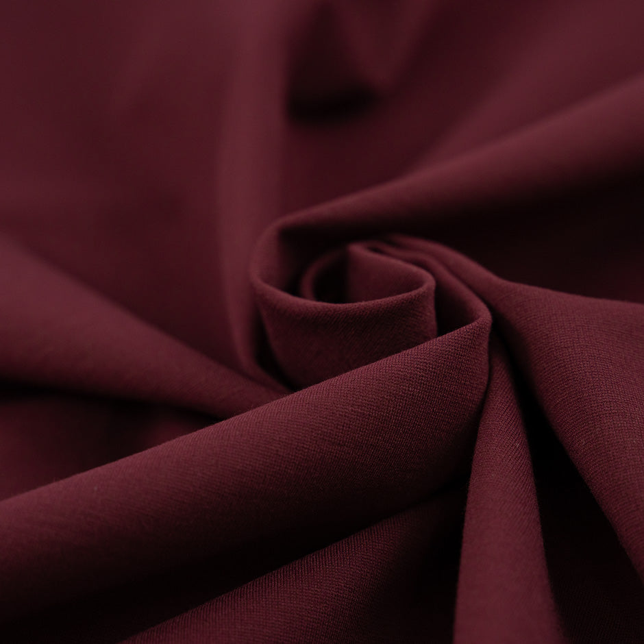 Punto Milano jersey of viscose and poliammide. The fabric is heavy, Stretch and bordeaux. High-quality deadstock collected in Stock from a Maison de Couture in Italy.