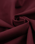 Punto Milano jersey of viscose and poliammide. The fabric is heavy, Stretch and bordeaux. High-quality deadstock collected in Stock from a Maison de Couture in Italy.