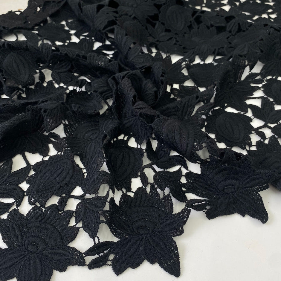 Black lace in wool and polyester with double scallop detail. Soft and elegant, ideal for dresses, skirts, and blouses. High-quality deadstock collected in Stock from a Maison de Couture in Italy.