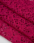 Fucsia lace wool and polyester with a geometric pattern. The fabric is stretch and falling. High-quality deadstock fabric collected in Stock from a Maison de Couture in Italy.