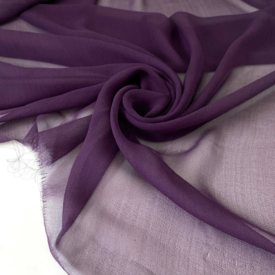 Pure silk chiffon in purple color reference Blackberry Wine. Very soft, light, flowy, and transparent. Ideal for light dresses, skirts, blouses, and shirting. High-quality deadstock collected in Stock from a Maison de Couture in Italy.