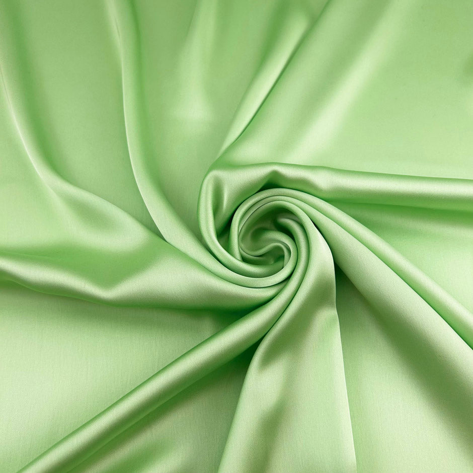 Light green polyester sateen with a soft, fluid drape and a non-stretch construction. Ideal for creating trousers and dresses. High-quality deadstock collected in Stock from a Maison de Couture in Italy.