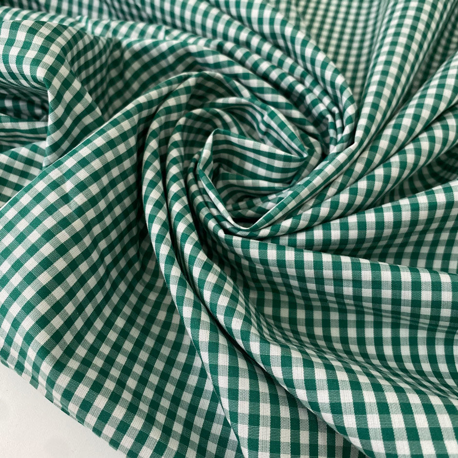 Pure cotton poplin with a small check design in shades of white and green. Very soft and light. Ieal for dresses, shirting, and skirts. High-quality deadstock collected in Stock from a Maison de Couture in Italy.