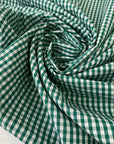 Pure cotton poplin with a small check design in shades of white and green. Very soft and light. Ieal for dresses, shirting, and skirts. High-quality deadstock collected in Stock from a Maison de Couture in Italy.