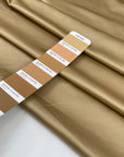 Polyester satin in beige sand very soft and shiny, not transparent and flowy. High-quality deadstock fabric collected in Stock from a Maison de Couture in Italy.