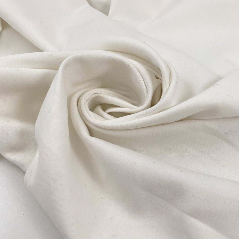 Heavy white cotton with slight stretch, very soft and warm to the touch, ideal for hoodies, jackets, trousers, and structured garments. High-quality deadstock collected in Stock from a Maison de Couture in Italy.