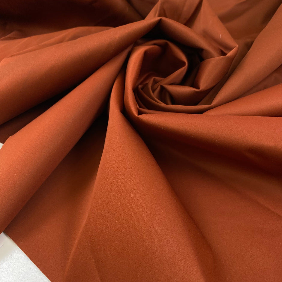Double-face waterproof fabric in wool, polyamide, silk and elastane. In cinnamon stick on one side and sand on the reverse. Ideal for outerwear. High-quality deadstock collected in Stock from a Maison de Couture in Italy.
