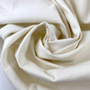 Stretch cotton gabardine in neutral white. Structured and solid. High-quality deadstock collected in Stock from a Maison de Couture in Italy.
