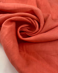 Linen and cotton in coral pink very soft and flowy. High-quality deadstock fabric collected in Stock from a Maison de Couture in Italy.