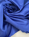 Solid color china blue polyester satin. High quality deadstock fabric picked up in Stock from a Maison de Couture in Italy.