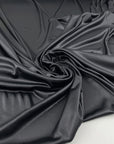 Shiny fluid polyester jersey with leather effect