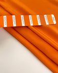 Flowing and falling orange silk crepe de chine fabric. High quality deadstock fabric picked up in Stock from a Maison de Couture in Italy.