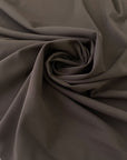 Dark brown polyester crepe, soft and fluid . Perfect dresses, skirts, blouses and shirts. High-quality deadstock collected in Stock from a Maison de Couture in Italy.