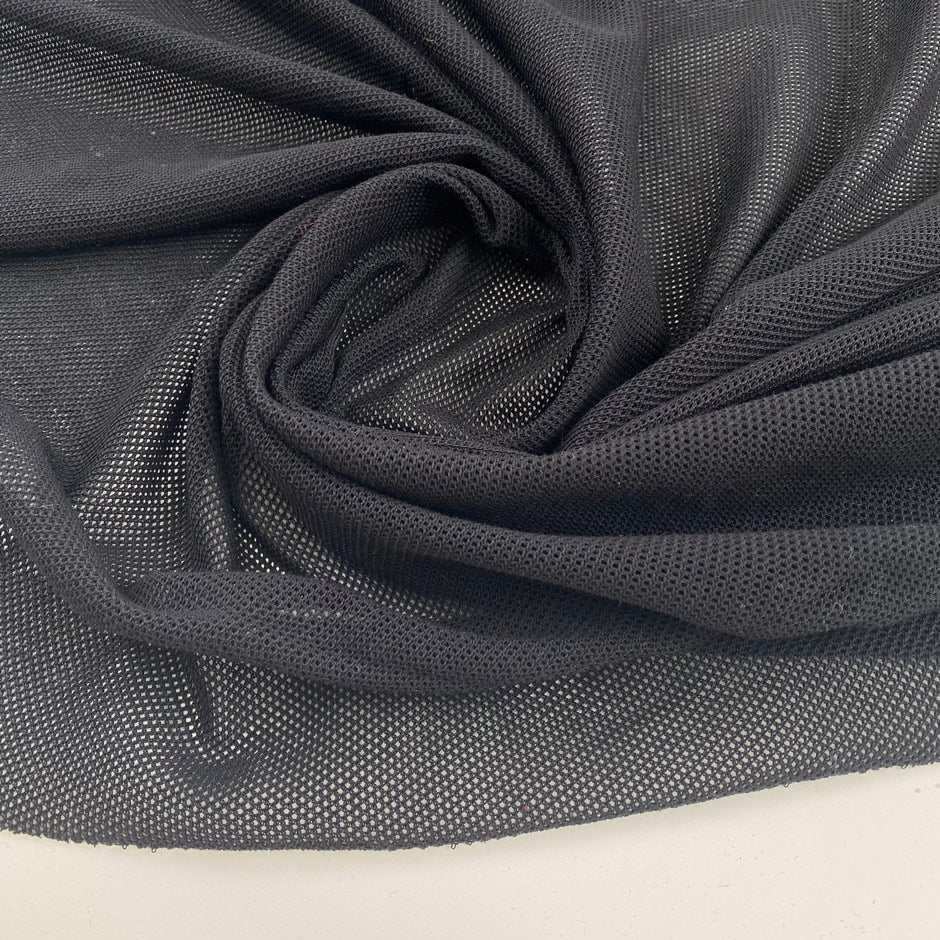 Black pure cotton mesh knit stretch and transparent. High-quality deadstock fabric collected in Stock from a Maison de Couture in Italy.