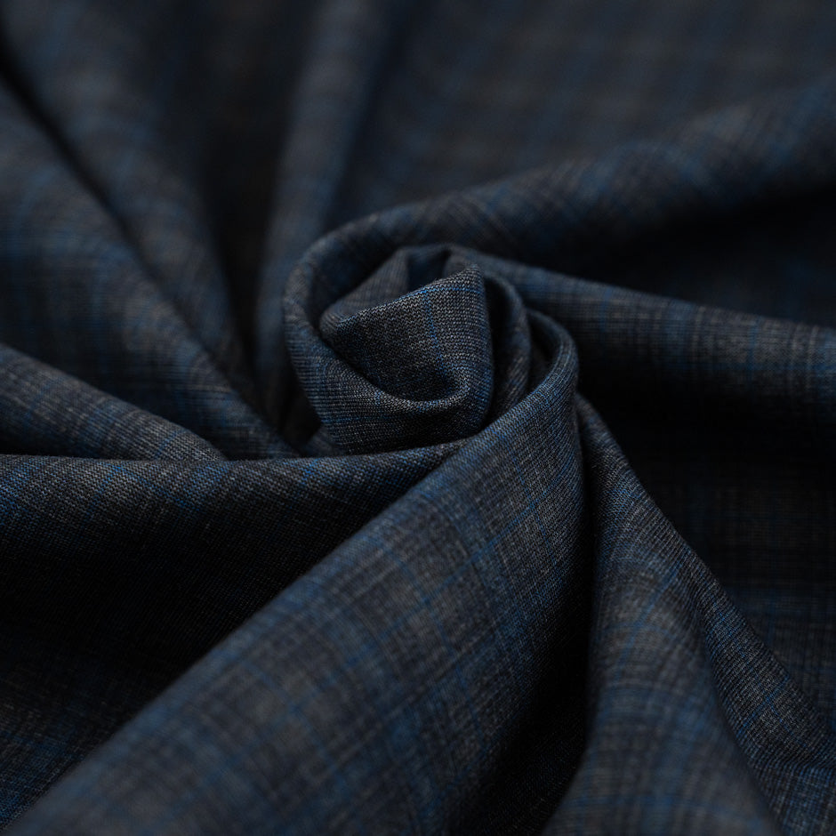 Punto Milano double-face viscose polyester. The fabric is squared printed, stretch, blue and black. High-quality deadstock collected in Stock from a Maison de Couture in Italy.