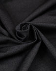 Black worked jersey polyester punto Milano double face. The fabric is stretched and has a black micro drawing. High-quality deadstock collected in Stock from a Maison de Couture in Italy.