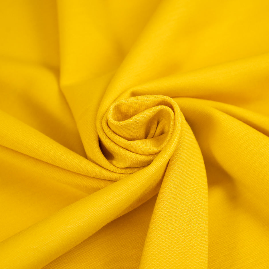 Yellow, stretchy jersey of viscose. High-quality deadstock fabric collected in Stock from a Maison de Couture in Italy.