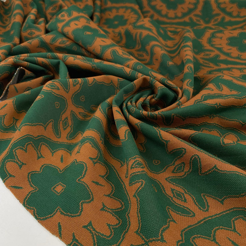 Heavy polyester elastane Punto Milano jersey with a beautiful paisley design in the shade forest green and leather brown. Ideal for structured dresses and tops. High-quality deadstock collected in Stock from a Maison de Couture in Italy.