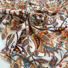 Pure viscose with a lurex stripe. The ground is white with a cashmere design in orange, light blue, and red shades. It is very soft and flowy. Ideal for dresses, blouses, shirts, and skirts. High-quality deadstock fabric by the meter collected in Stock from a Maison de Couture in Italy.