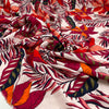 Printed viscose with tropical flower design in white, fuchsia, orange, and red shades. Very soft, light, and flowy. High-quality deadstock fabric by the meter collected in Stock from a Maison de Couture in Italy.