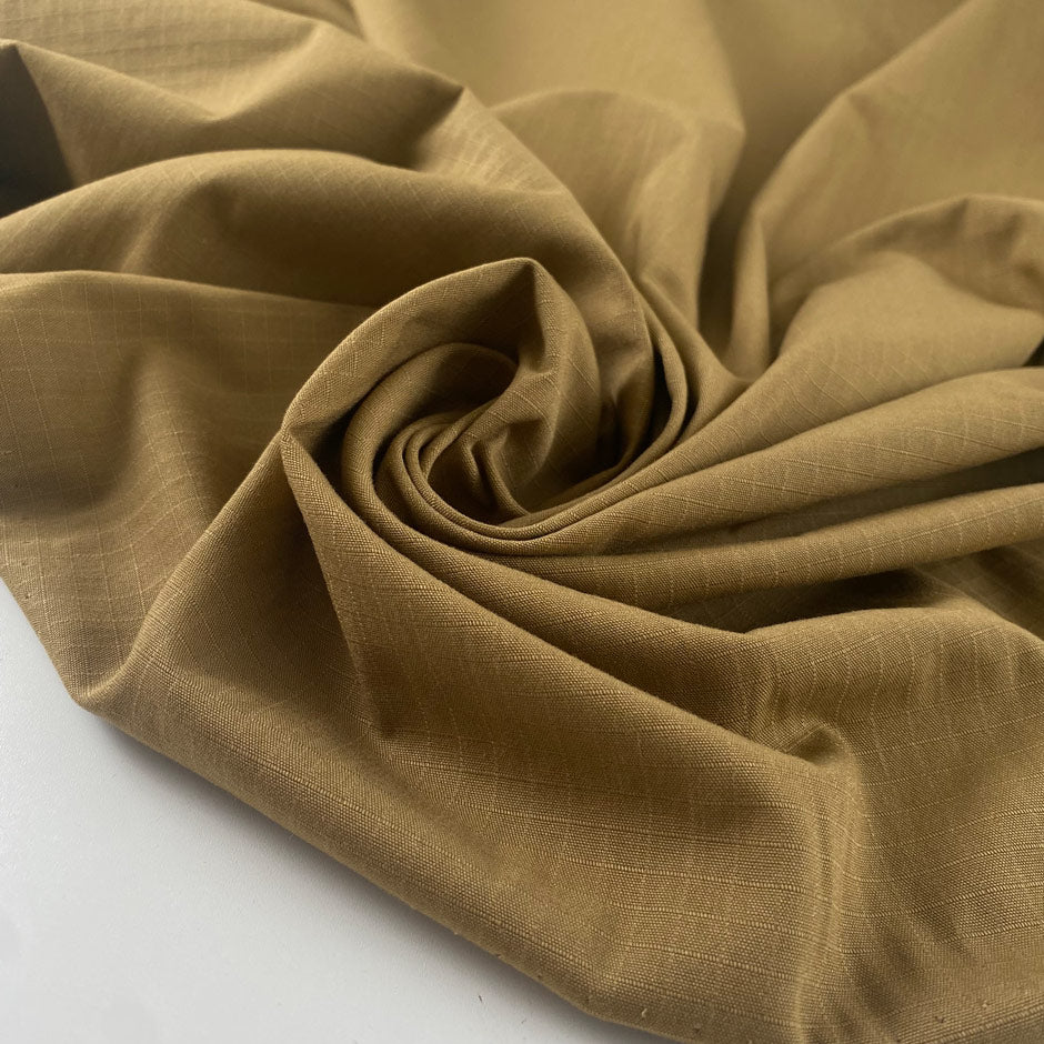 Durable olive green cotton ripstop with a textured grid weave ideal for utility garments outerwear and accessories. High-quality deadstock collected in Stock from a Maison de Couture in Italy.