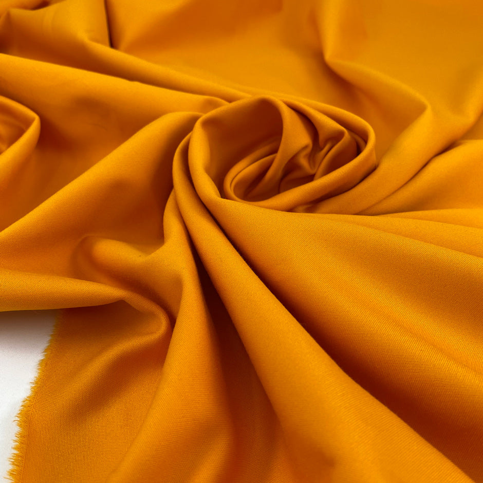 Heavy and soft cotton with elastane, in apricot orange. High-quality deadstock fabric collected in Stock from a Maison de Couture in Italy.