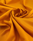 Heavy and soft cotton with elastane, in apricot orange. High-quality deadstock fabric collected in Stock from a Maison de Couture in Italy.