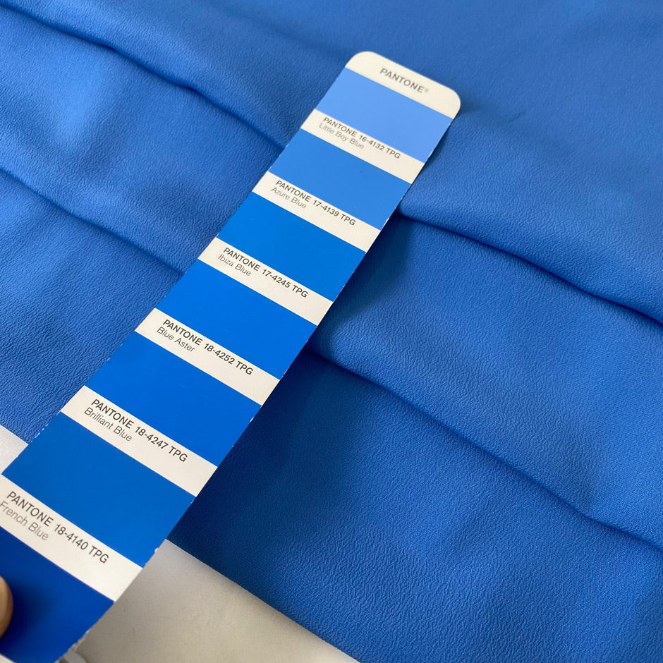 Silk and acetate crêpe de chine in light blue color reference Azure Blue. Very soft and light, flowy and not transparent. Ideal for shirting, blouses, dresses, and skirts. High-quality deadstock collected in Stock from a Maison de Couture in Italy.