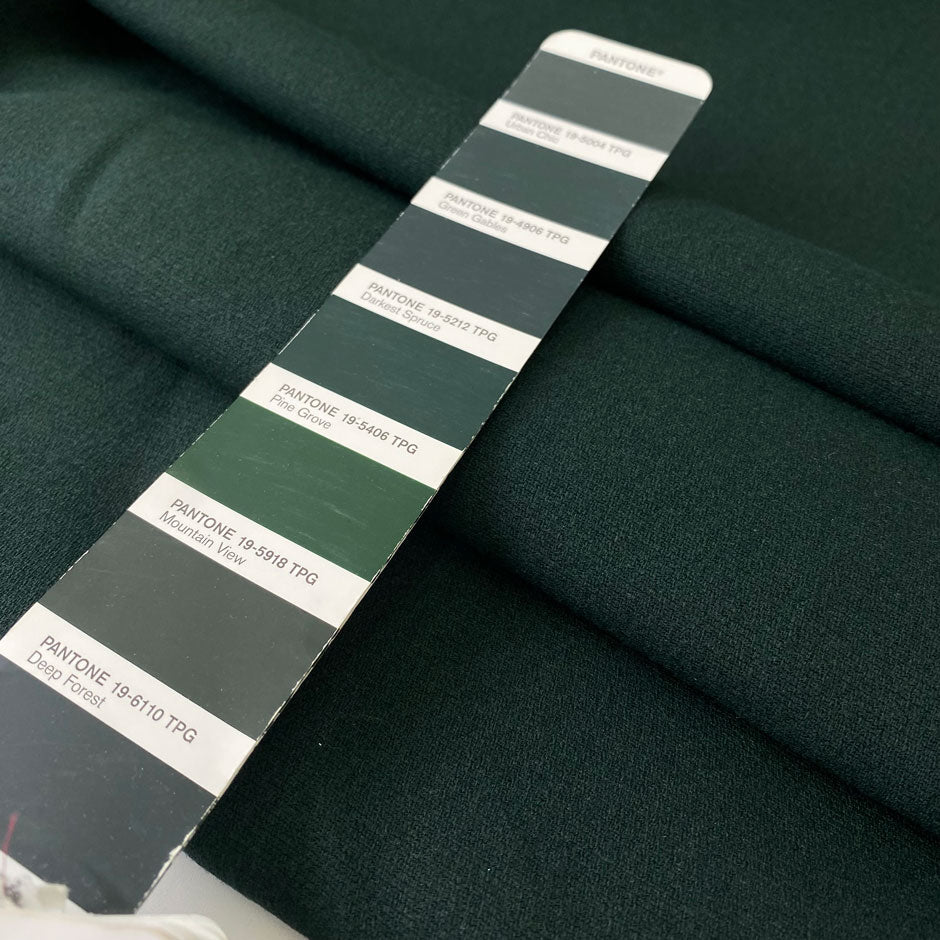 Soft and flowing wool and viscose stretch double crêpe in dark green. Perfect for jackets, skirts, and dresses.High-quality deadstock collected in Stock from a Maison de Couture in Italy.