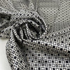 Polyester and elastane satin with small geometric design in shades of grey, white, and black, very soft, light, flowy, not transparent, with a shiny effect. High-quality deadstock collected in Stock from a Maison de Couture in Italy.