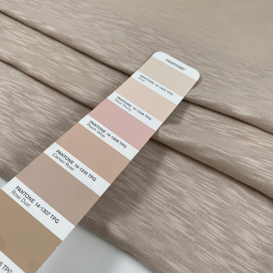 Pure cotton stretch jersey in pink beige, color reference Shell. Very soft and flowy with a slightly rough texture. High-quality deadstock collected in Stock from a Maison de Couture in Italy.