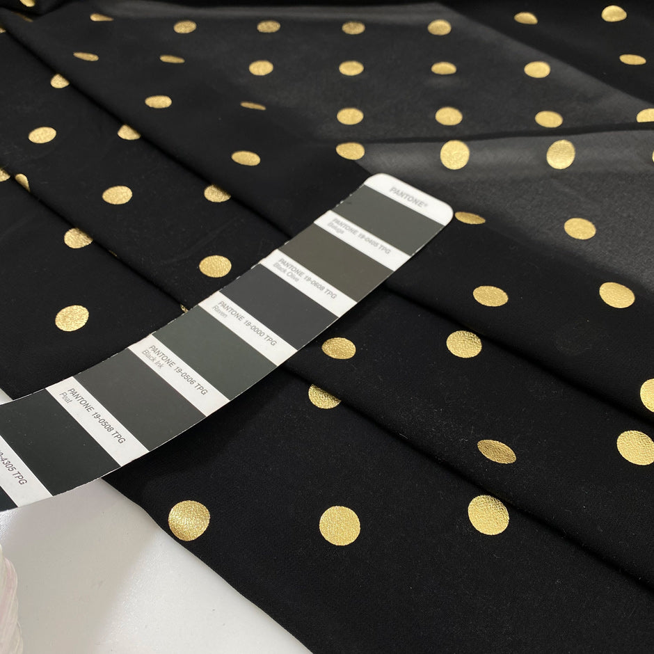 Polyester georgette transparent in black color with cool and gold polka dots, very soft and light. High-quality deadstock fabric collected in Stock from a Maison de Couture in Italy.