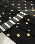 Polyester georgette transparent in black color with cool and gold polka dots, very soft and light. High-quality deadstock fabric collected in Stock from a Maison de Couture in Italy.