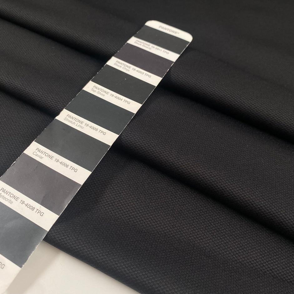 Stretch jersey piquet in polyester and elastane, black color reference Tap Shoe. Very soft, flowy, medium weight and not transparent. Ideal for trousers, dresses, skirts, and jackets. High-quality deadstock collected in Stock from a Maison de Couture in Italy.