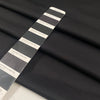 Stretch jersey piquet in polyester and elastane, black color reference Tap Shoe. Very soft, flowy, medium weight and not transparent. Ideal for trousers, dresses, skirts, and jackets. High-quality deadstock collected in Stock from a Maison de Couture in Italy.