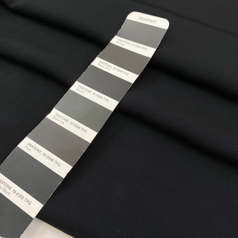 Polyester cady in black color reference Pirate Black. Very soft and flowy, not transparent, ideal for trousers, skirts, and dresses. High-quality deadstock collected in Stock from a Maison de Couture in Italy.