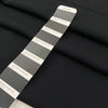 Polyester cady in black color reference Pirate Black. Very soft and flowy, not transparent, ideal for trousers, skirts, and dresses. High-quality deadstock collected in Stock from a Maison de Couture in Italy.