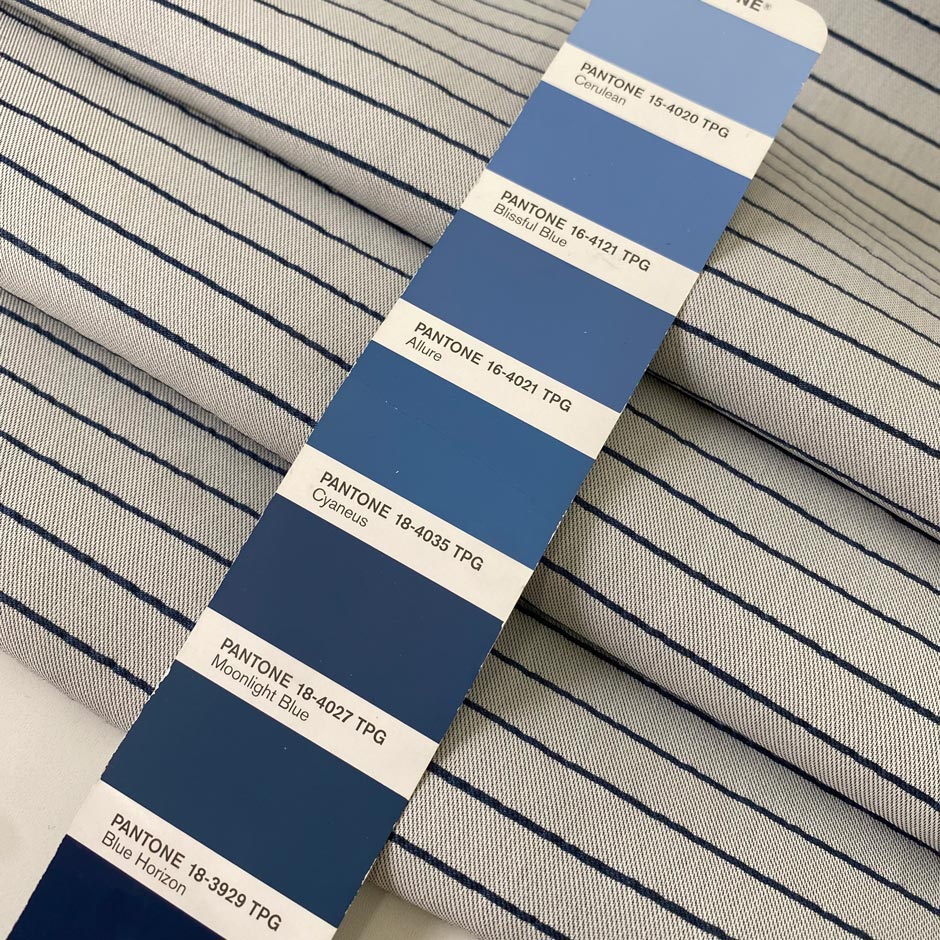 Heavy taffeta in a mix of polyester, silk, and cotton. Gray ground with blue stripes, heavy and stiff. Ideal for structured jackets, dresses, or skirts. High-quality deadstock collected in Stock from a Maison de Couture in Italy.