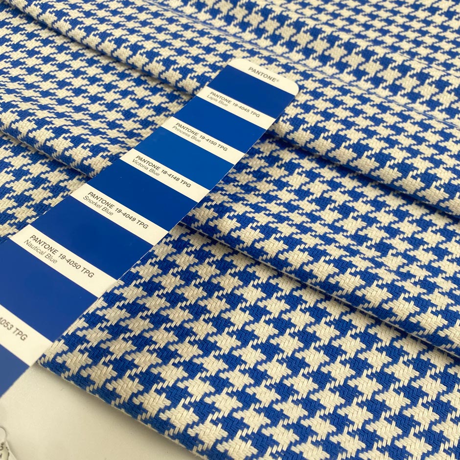 Mixed cotton tweed with a white ground and blue pied de poule pattern, color reference Victoria Blue. Very soft, light, flowy, and not transparent. Ideal for dresses, trousers, skirts, and jackets. High-quality deadstock collected in Stock from a Maison de Couture in Italy.