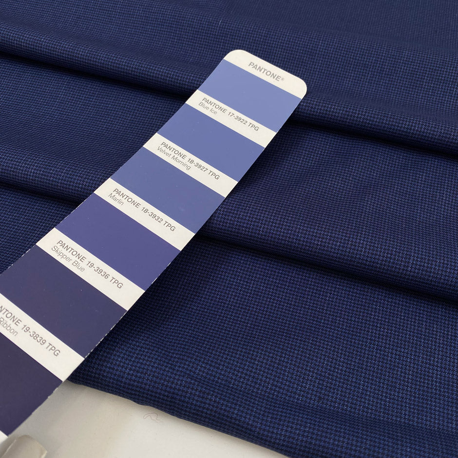 Virgin wool and silk in dark blue, with very small pied de pooule pattern in black. Very light and soft. &nbsp;High-quality deadstock fabric by the meter collected in Stock from a Maison de Couture in Italy.