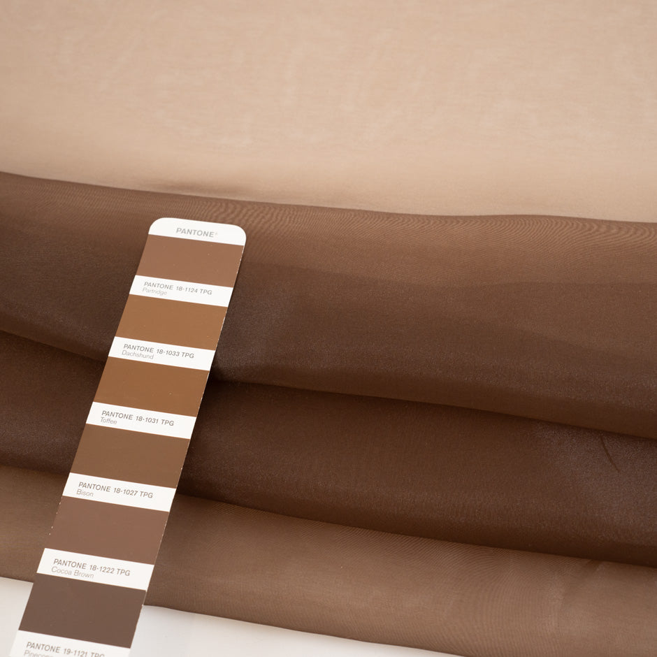 Very light and soft brown polyester organza. High-quality deadstock fabric collected in Stock from a Maison de Couture in Italy.