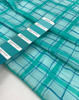 Soft, light, and transparent pure cotton batiste with check design in turquoise and blue shades. High-quality deadstock fabric collected in Stock from a Maison de Couture in Italy.