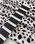 Polyester satin with stretch in black and white animal print. Shiny, very soft and light, flowy and not transparent. Ideal for dresses, skirts, blouses, and shirting. High-quality deadstock collected in Stock from a Maison de Couture in Italy.