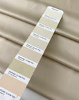 Polyester satin in cream color. Very soft, light, and flowy. Not transparent. Ideal for dresses, skirts, blouses, and shirting. High-quality deadstock collected in Stock from a Maison de Couture in Italy.