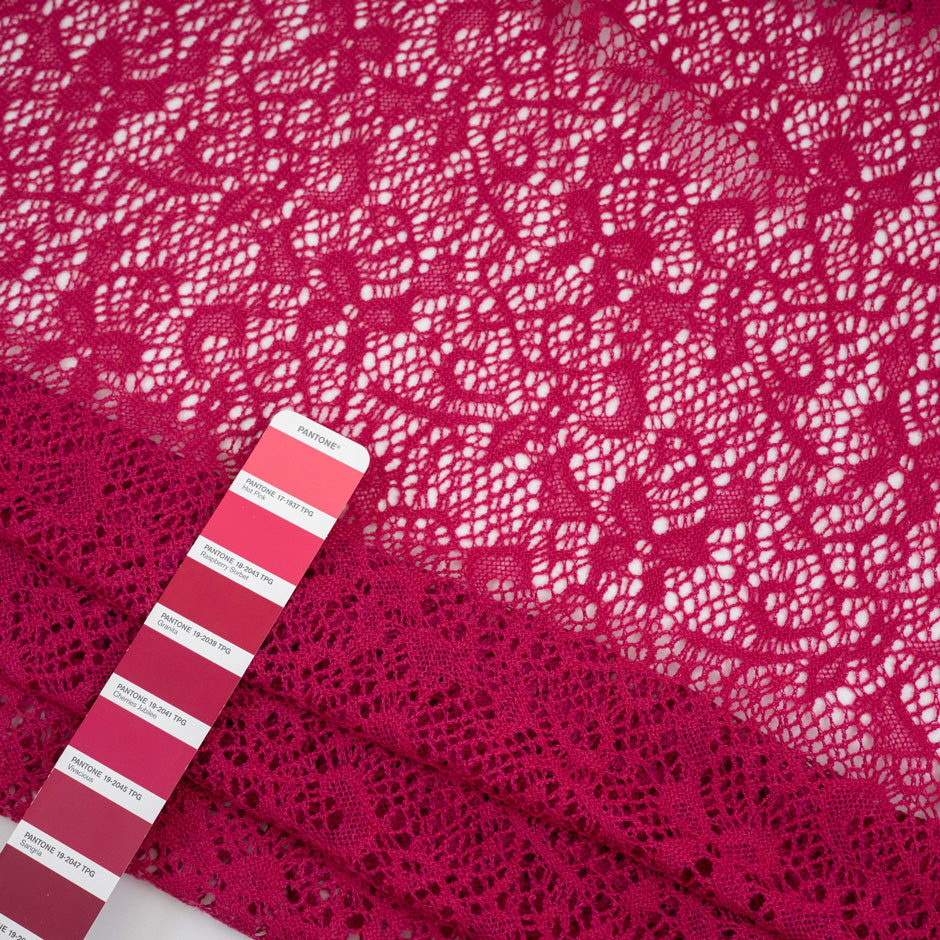 Fucsia lace wool and polyester with a geometric pattern. The fabric is stretch and falling. High-quality deadstock fabric collected in Stock from a Maison de Couture in Italy.