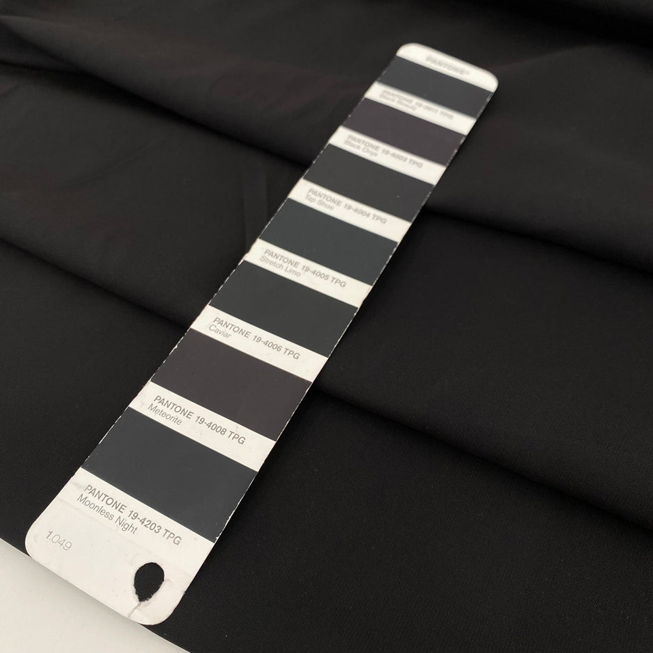 Very soft and flowing polyester georgette in a dark gray shade, color reference Meteorite. Ideal for dresses, skirts, blouses, and shirting. High-quality deadstock collected in Stock from a Maison de Couture in Italy.